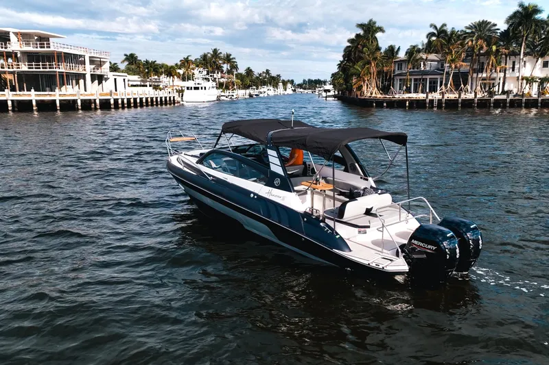 Slide: The Image of Luxury Hanover 305 boat cruising on a scenic waterway, 2027 model. - 3
