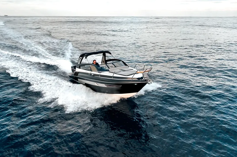 Slide: The Image of A 2027 Hanover 305 boat cruising swiftly on open water. - 4
