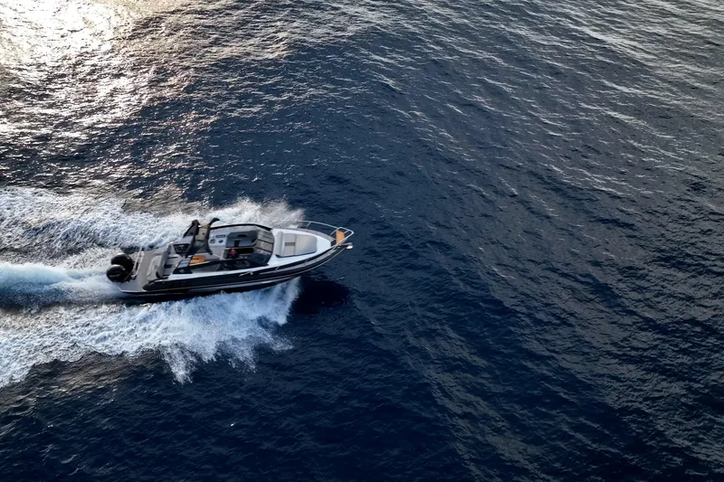 Slide: The Image of Aerial view of 2027 Hanover 305 boat cruising on open water. - 8