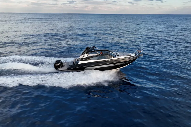 Slide: The Image of A sleek 2027 Hanover 305 speedboat cruising on open water under a clear sky. - 9