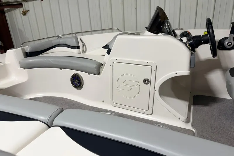 Slide: The Image of Interior of a 2014 Starcraft 2000 IO Limited boat with seating and control panel. - 12