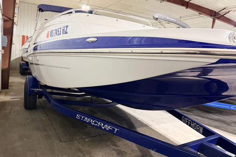 Slide: The Image of 2014 Starcraft 2000 IO Limited boat on trailer in indoor storage facility. - 16