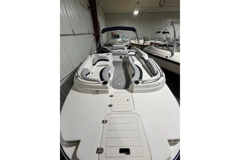 Slide: The Image of 2014 Starcraft 2000 IO Limited boat with spacious seating in a storage facility. - 25