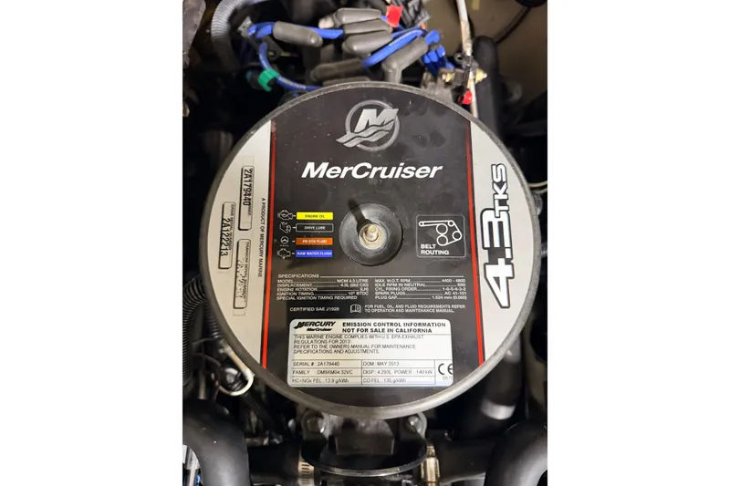 Slide: The Image of Engine cover of a 2014 Starcraft 2000 IO Limited with MerCruiser 4.3 TKS specifications. - 28