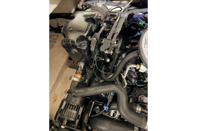 Slide: The Image of Engine compartment of a 2014 Starcraft 2000 IO Limited boat, showcasing detailed components. - 29