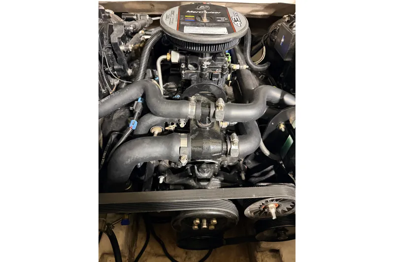 Slide: The Image of Engine of a 2014 Starcraft 2000 IO Limited boat, featuring hoses and pulleys. - 32
