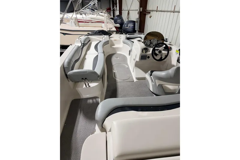 Slide: The Image of 2014 Starcraft 2000 IO Limited boat interior with seating and steering wheel. - 34