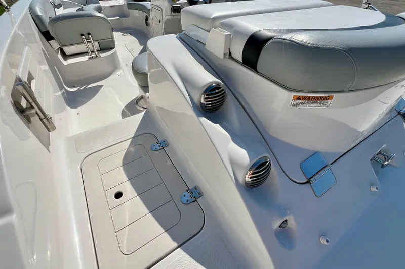 Slide: The Image of Interior view of a 2014 Starcraft 2000 IO Limited boat with seating and storage. - 6