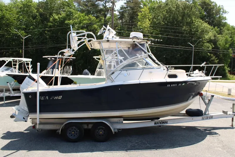 Slide: The Image of 2002 Sea Pro 235WA boat parked on trailer outdoors. - 2