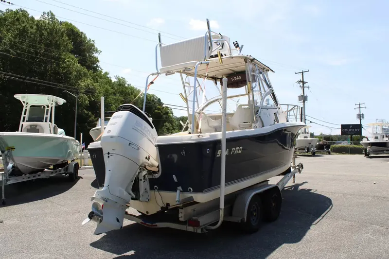 Slide: The Image of 2002 Sea Pro 235WA boat parked outdoors on a trailer. - 3