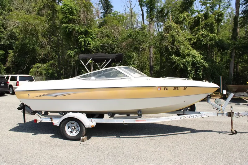 The Image of 2004 Stingray 180 LX boat parked on trailer outdoors. - 1
