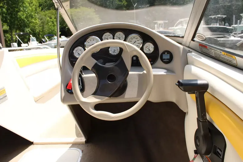 Slide: The Image of Interior view of a 2004 Stingray 180 LX boat with steering wheel and dashboard. - 12