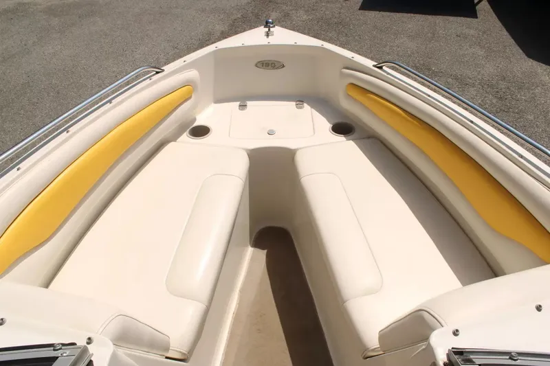 Slide: The Image of Interior of a 2004 Stingray 180 LX boat with yellow accents. - 14