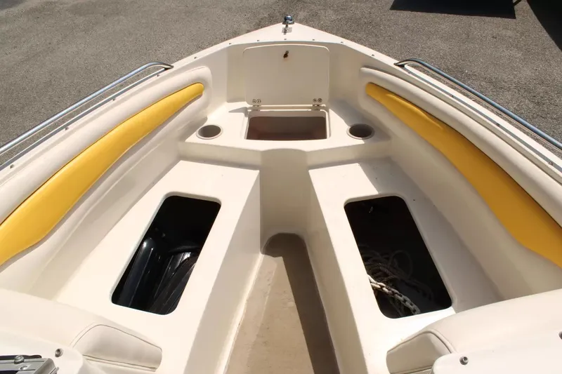 Slide: The Image of Interior view of a 2004 Stingray 180 LX boat with yellow cushions. - 15