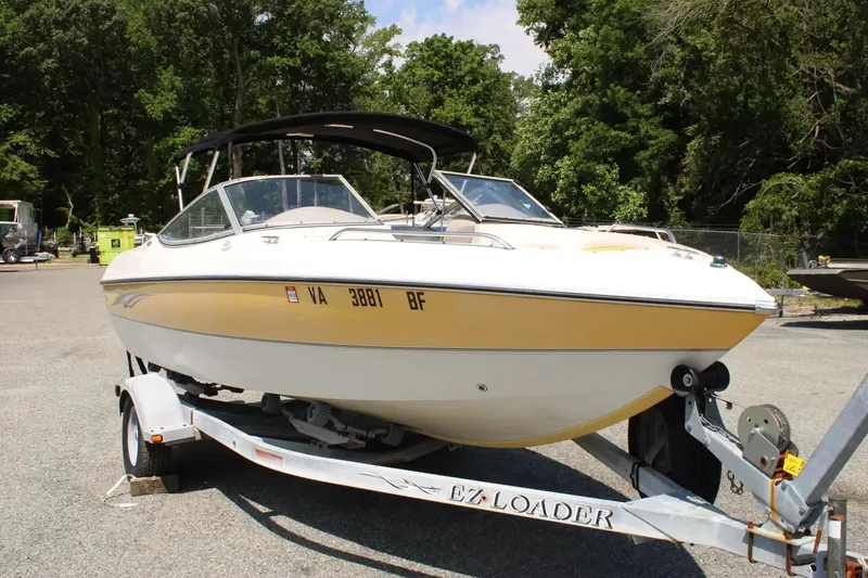 Slide: The Image of 2004 Stingray 180 LX boat parked on trailer outdoors. - 2