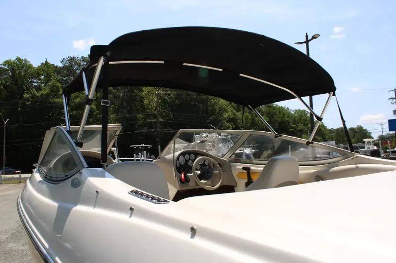 Slide: The Image of 2004 Stingray 180 LX boat with black canopy outdoors. - 22