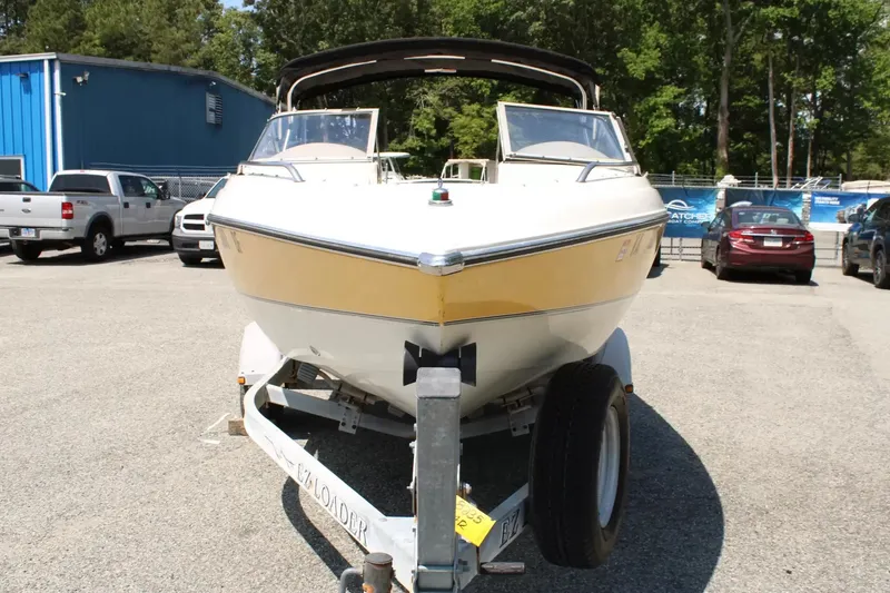 Slide: The Image of 2004 Stingray 180 LX boat parked on trailer outdoors. - 3