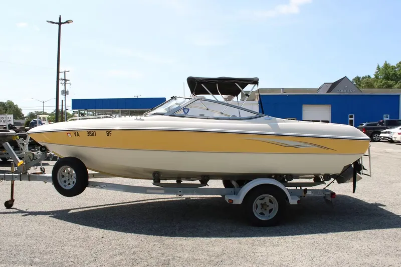 Slide: The Image of 2004 Stingray 180 LX boat on trailer outdoors. - 5
