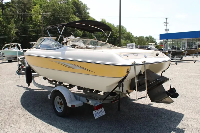 Slide: The Image of 2004 Stingray 180 LX boat on trailer outdoors. - 6