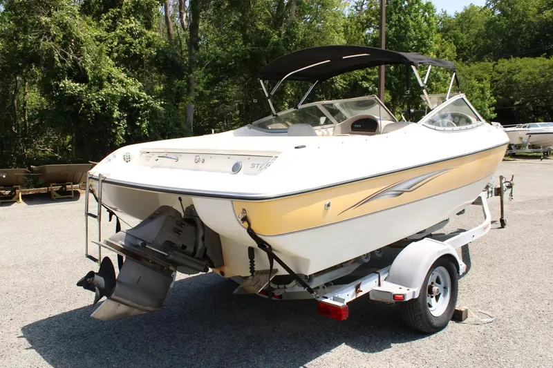 Slide: The Image of 2004 Stingray 180 LX boat parked on trailer outdoors. - 8