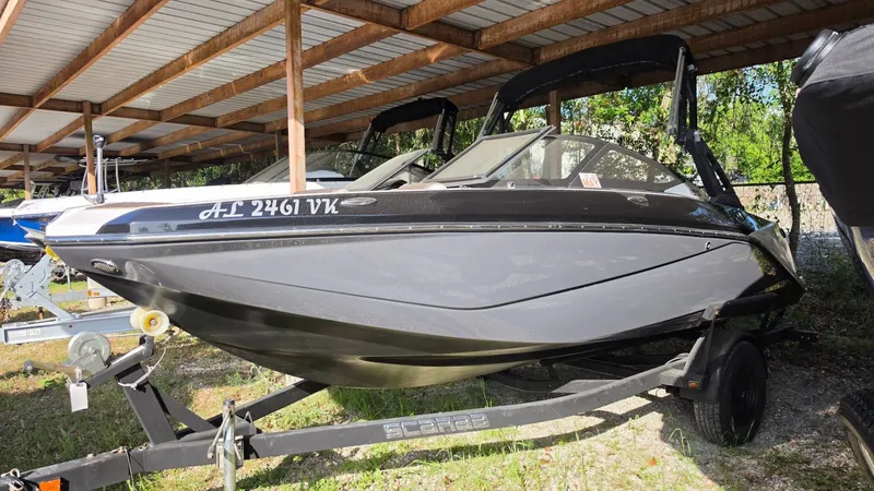 The Image of 2019 Scarab 195 ID boat under a covered shelter. - 1