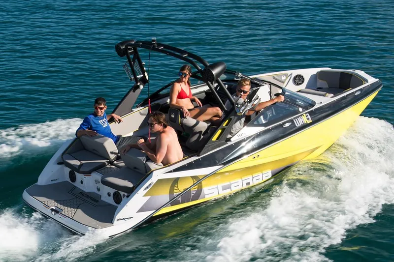 Slide: The Image of 2019 Scarab 195 ID boat on water with passengers. - 11