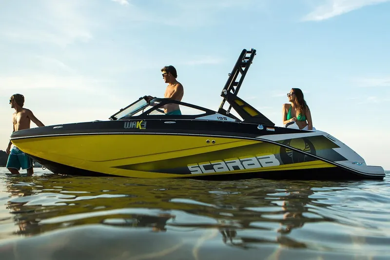 Slide: The Image of 2019 Scarab 195 ID boat on water with people. - 12