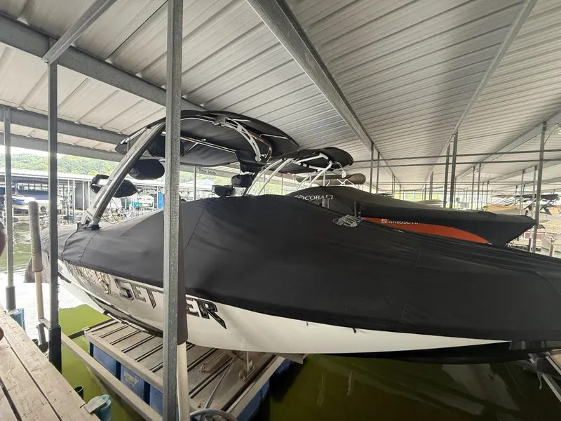 The Image of 2012 Malibu Wakesetter 23 LSV covered in boathouse. - 1