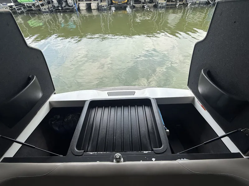 Slide: The Image of 2012 Malibu Wakesetter 23 LSV boat storage compartments by the water. - 15