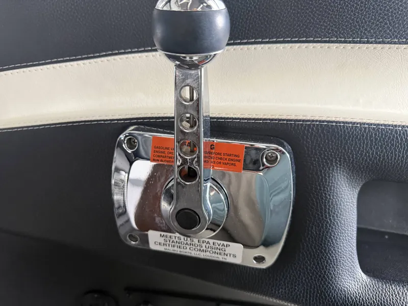 Slide: The Image of 2012 Malibu Wakesetter 23 LSV throttle lever with warning labels. - 24