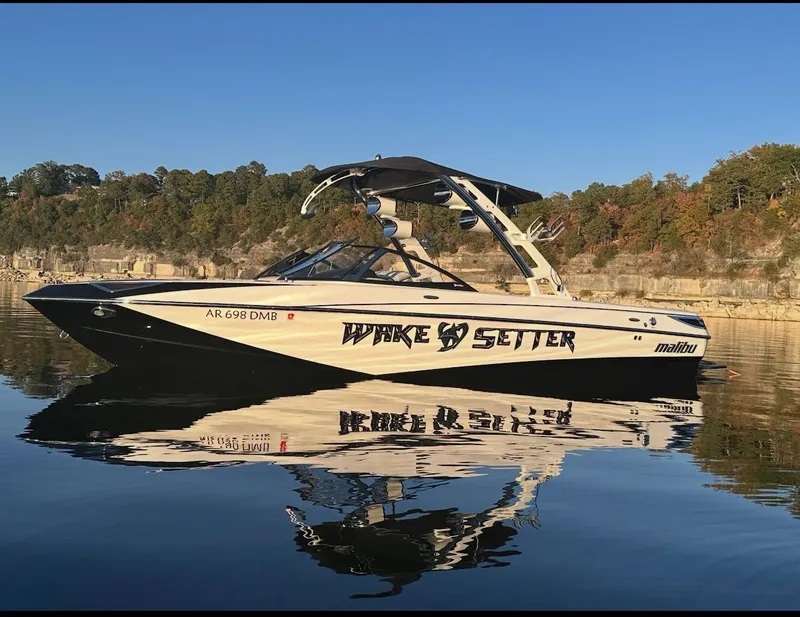 Slide: The Image of 2012 Malibu Wakesetter 23 LSV on calm water near wooded shoreline. - 33