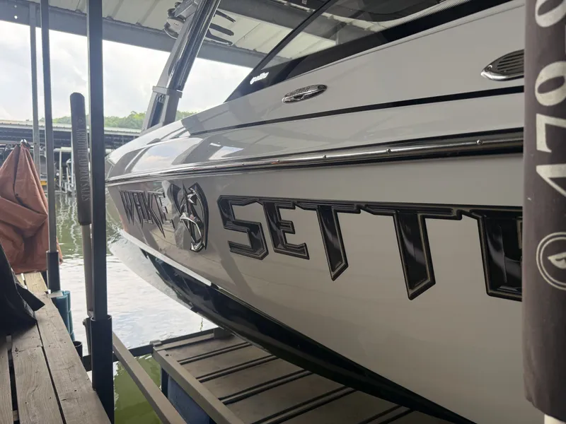 Slide: The Image of 2012 Malibu Wakesetter 23 LSV boat docked at marina. - 6