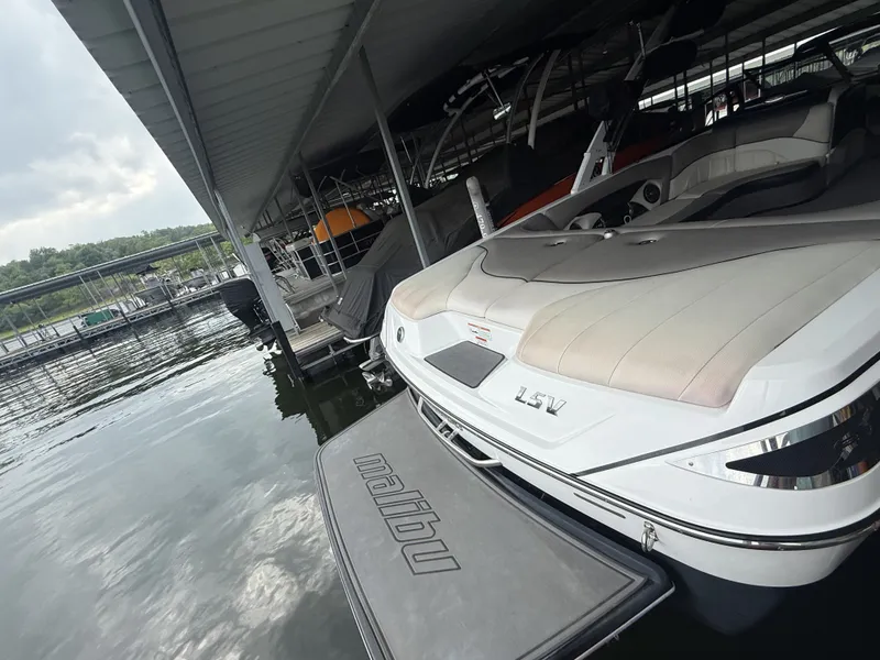 Slide: The Image of 2012 Malibu Wakesetter 23 LSV boat docked at marina. - 7