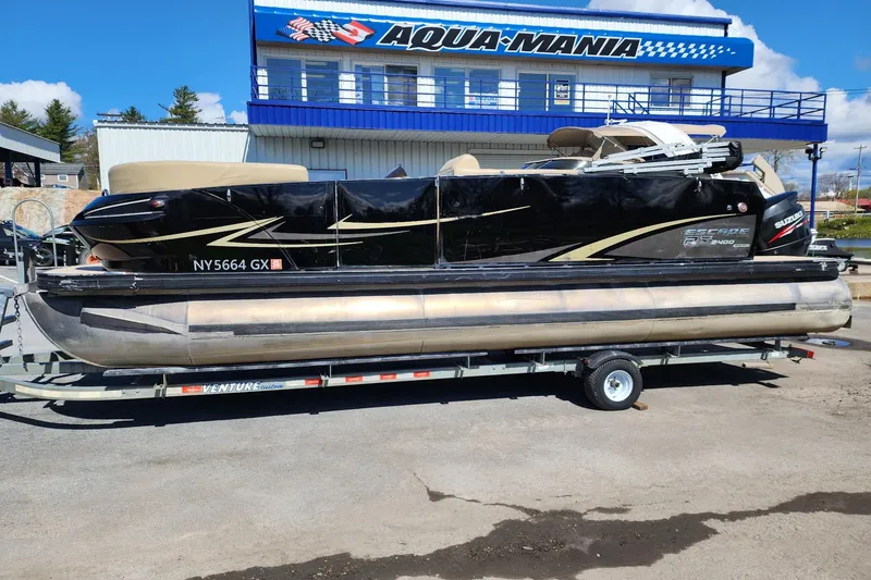 The Image of 2017 Larson Escape RT 2400 Cruise Triple pontoon boat on trailer at Aqua-Mania dealership. - 1