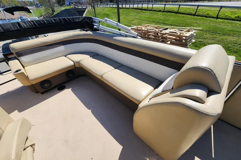 Slide: The Image of 2017 Larson Escape RT 2400 Cruise Triple boat interior with beige seating. - 10