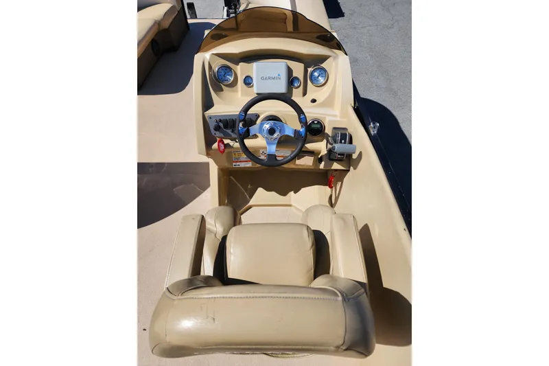 Slide: The Image of 2017 Larson Escape RT 2400 Cruise Triple boat dashboard with steering wheel and controls. - 12