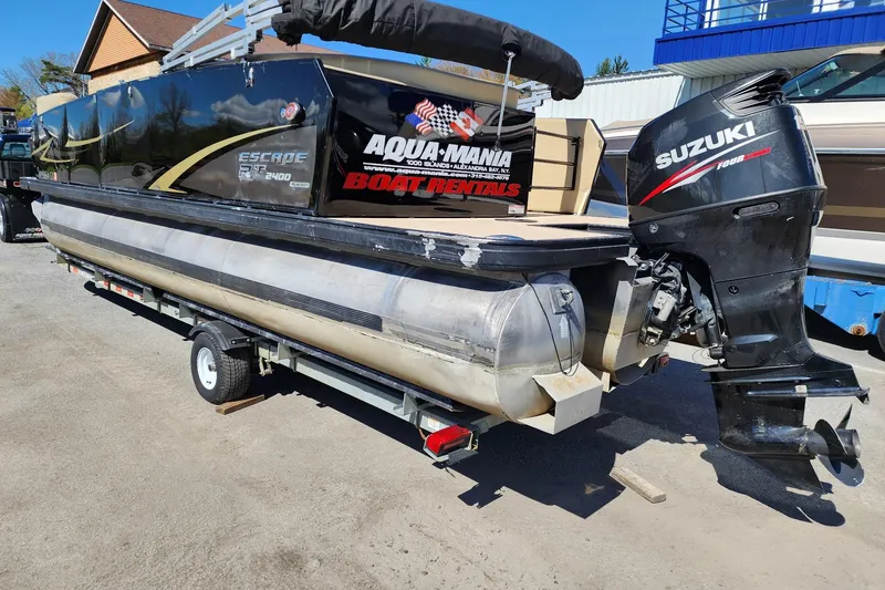 Slide: The Image of 2017 Larson Escape RT 2400 Cruise Triple pontoon boat with Suzuki outboard motor on trailer. - 7