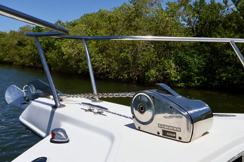 Slide: The Image of 2002 Pro-Line 32 Express boat with Lewmar anchor winch, docked near lush greenery. - 10
