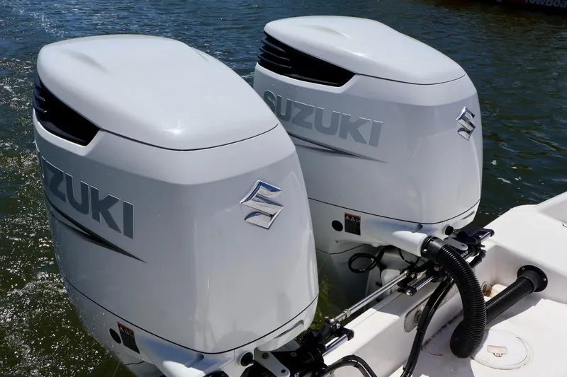 Slide: The Image of Twin Suzuki outboard motors on a 2002 Pro-Line 32 Express boat. - 11