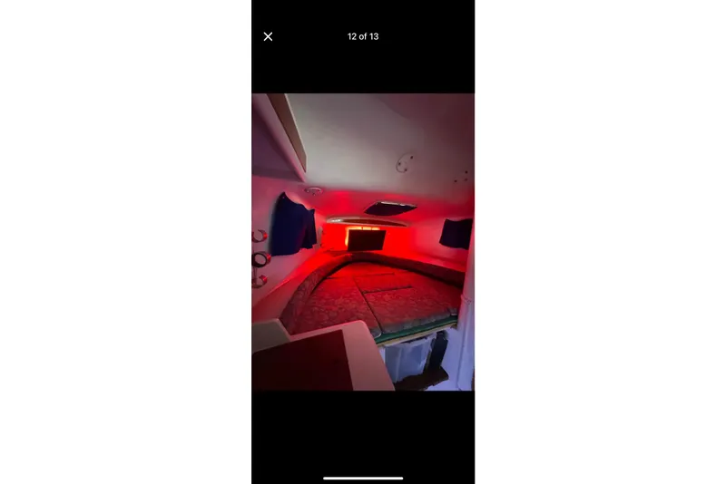 Slide: The Image of Interior cabin of 2002 Pro-Line 32 Express boat with red lighting. - 12