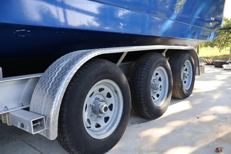 Slide: The Image of Trailer with triple axles for 2002 Pro-Line 32 Express boat. - 13