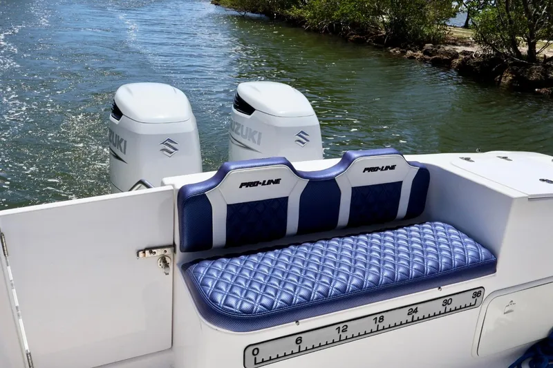 Slide: The Image of 2002 Pro-Line 32 Express boat with Suzuki engines and blue quilted seating. - 5