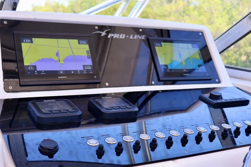 Slide: The Image of Control panel of a 2002 Pro-Line 32 Express boat with Garmin navigation displays. - 8