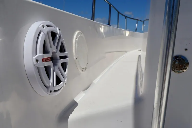 Slide: The Image of Close-up of a 2002 Pro-Line 32 Express boat speaker and railing under a clear blue sky. - 9