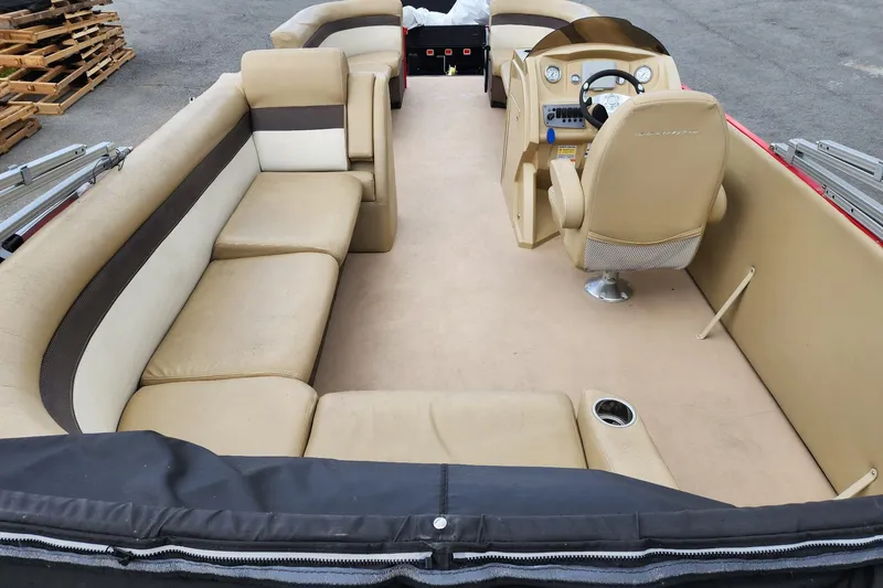 Slide: The Image of 2017 Larson Escape RT 2400 Cruise Triple pontoon boat interior with beige seating and helm. - 11