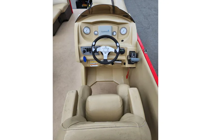 Slide: The Image of 2017 Larson Escape RT 2400 Cruise Triple boat dashboard with steering wheel and controls. - 12