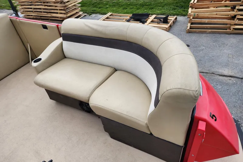 Slide: The Image of 2017 Larson Escape RT 2400 Cruise Triple boat seat with beige upholstery and cup holder. - 14