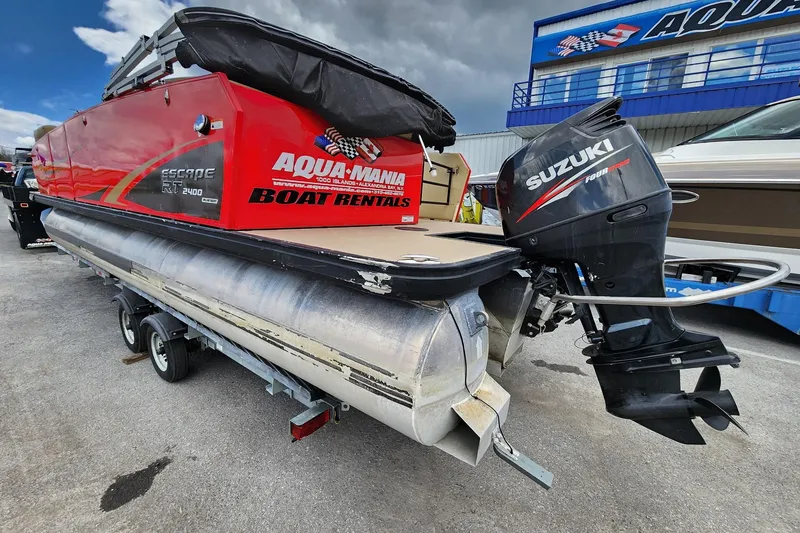 Slide: The Image of 2017 Larson Escape RT 2400 Cruise Triple pontoon boat with Suzuki outboard motor, available for rental. - 6