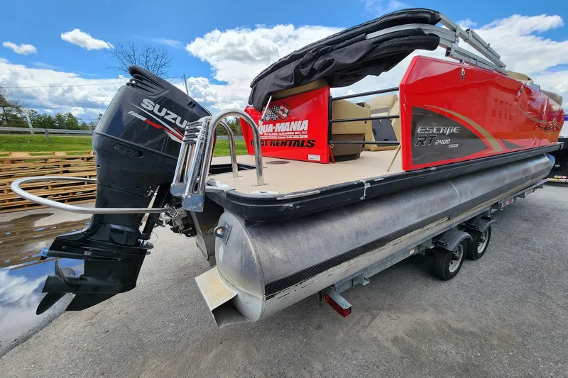 Slide: The Image of 2017 Larson Escape RT 2400 Cruise Triple pontoon boat with Suzuki outboard motor on trailer. - 7