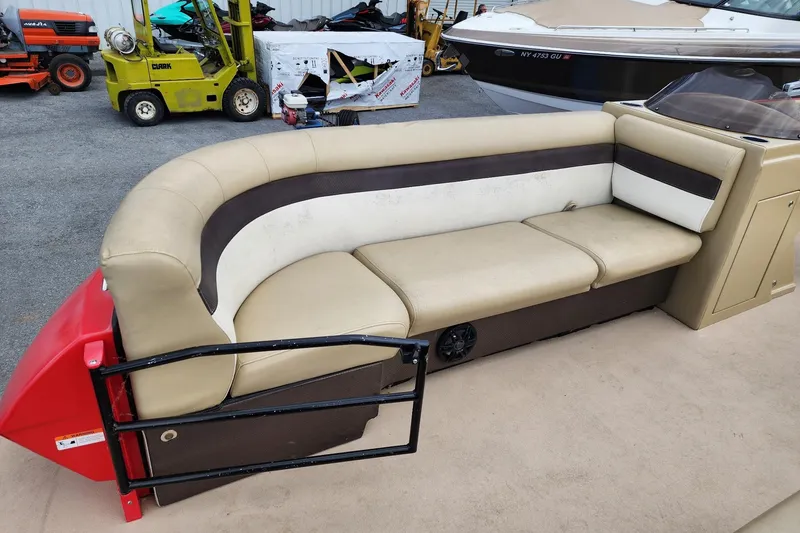 Slide: The Image of 2017 Larson Escape RT 2400 Cruise Triple boat interior with beige seating and black railing. - 9